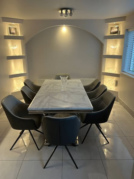 Finished media wall with lit display niches and dining area