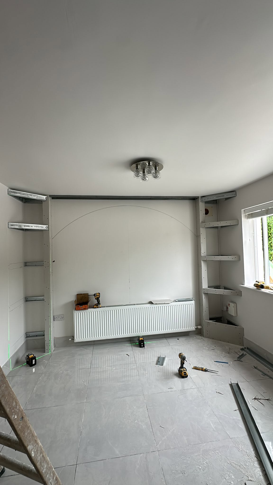 Metal stud framework for the TV wall and shelving niches