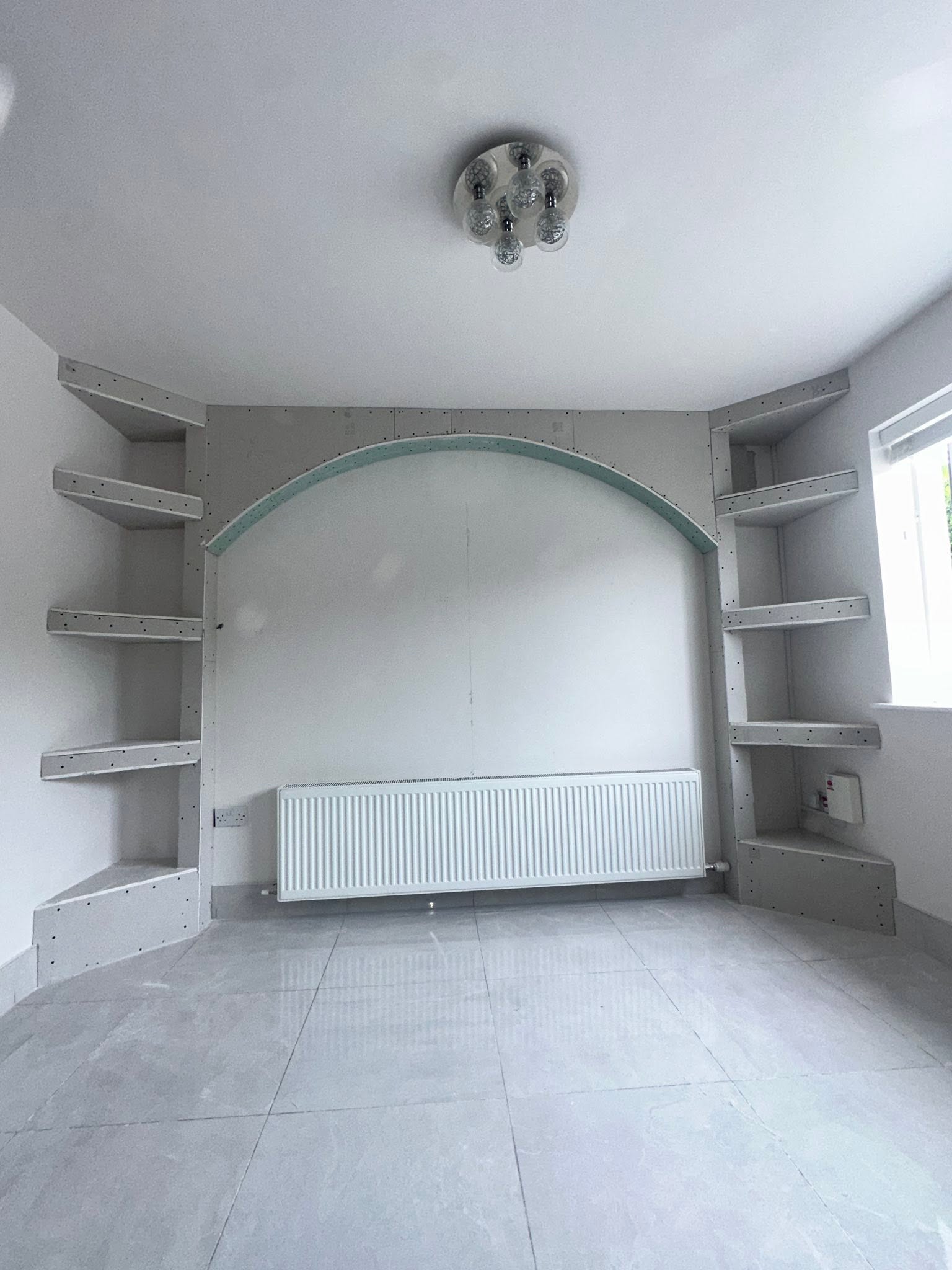 Plasterboard fixed to the framework with an arch and recesses